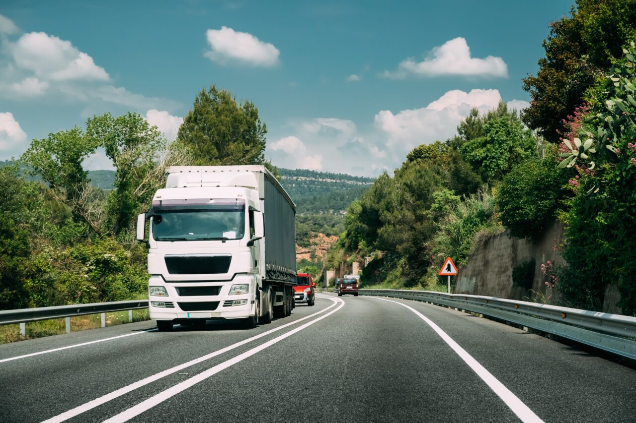 White truck driving on a road