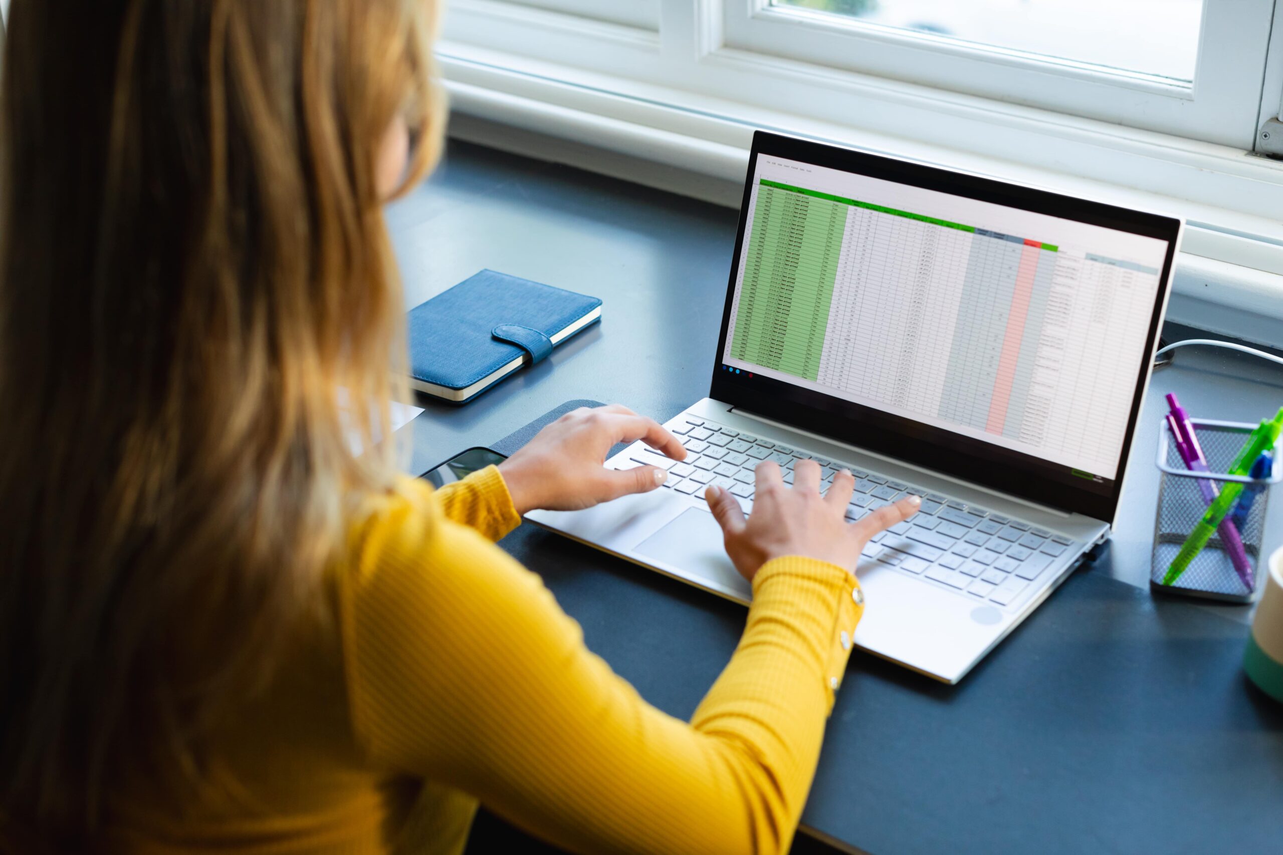 Woman planning delivery routes on a spreadsheet