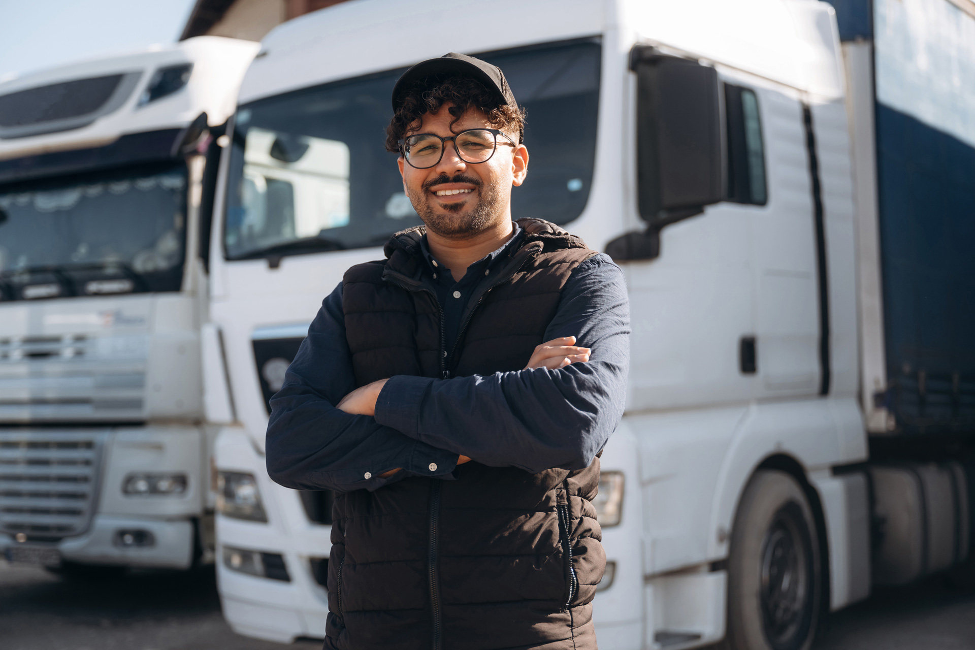 Explore Transport Featured Image showing male worker standing in front of HGV
