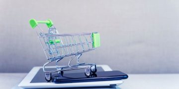 Shopping trolley on laptop and phone